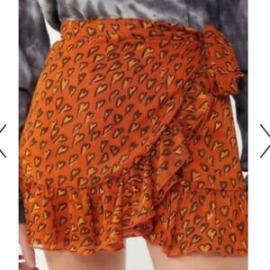 Urban Outfitters faux wrap ruffled bow tie Miniskirt.Mini hearts brown/orange.XS